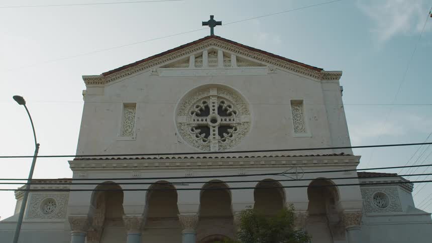 Facade of a small church under a blue sky in the morning