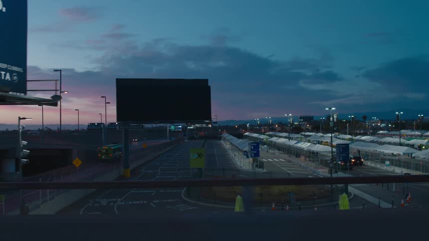 A view of a bus station outdoors at dusk