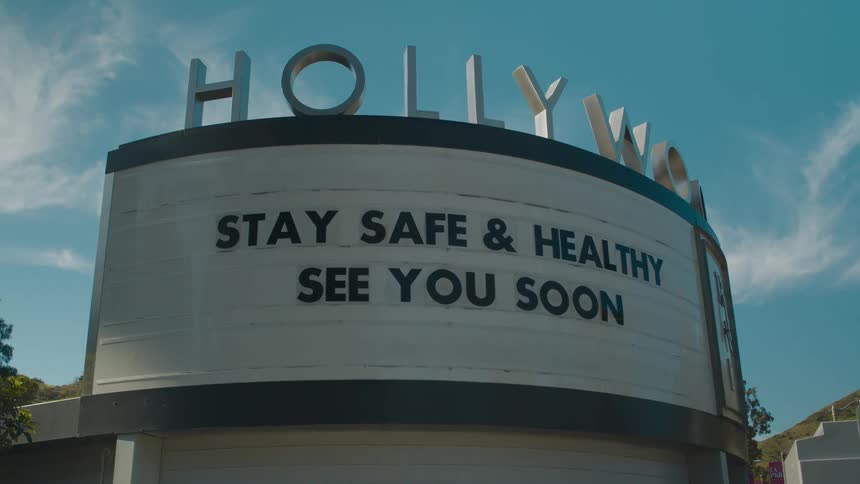 A view of a movie theater with a sign outside