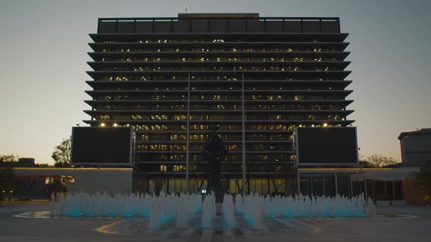 A fountain in front of an office building