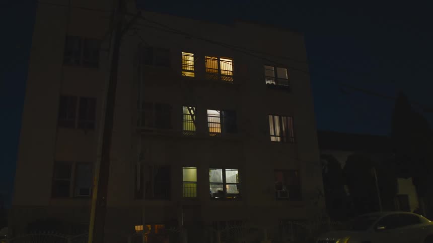 Cars are driving through a city at night