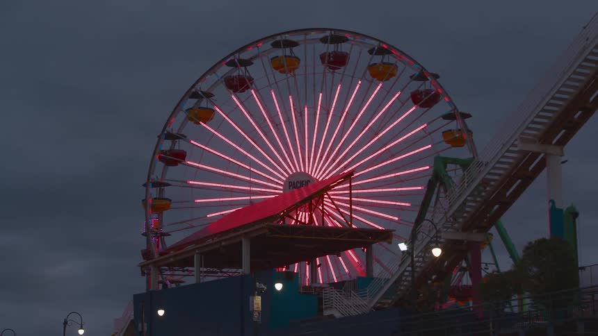 The lights on a ferris wheel are making a heart shaped pattern