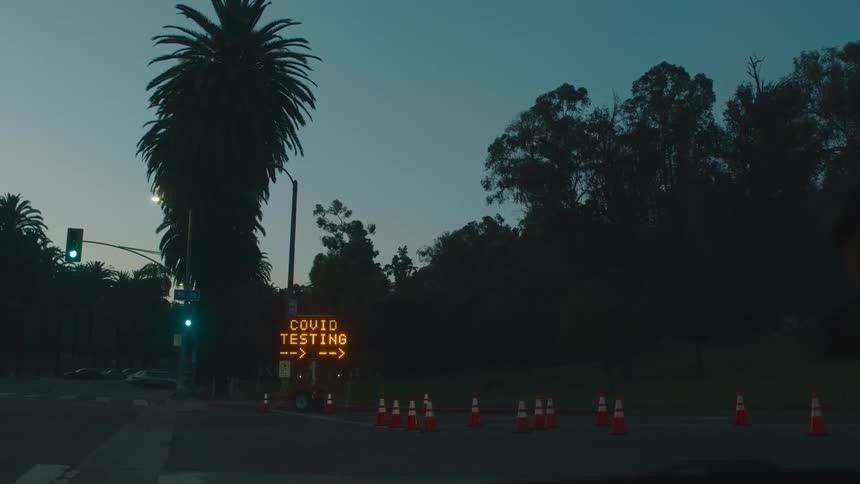 Led highway sign for covid testing on a road in a small town at evening