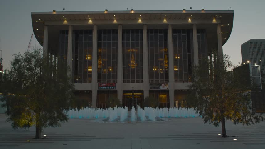 Fountain in front of a convention center building in the city at sunset