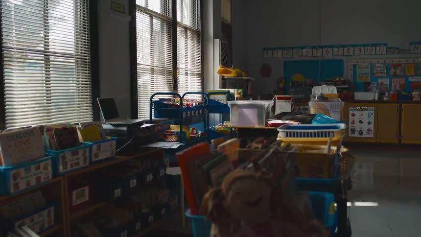 School supplies sit in labeled bins in a classroom