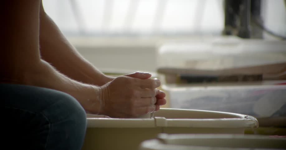 Person molding clay spinning in front of them