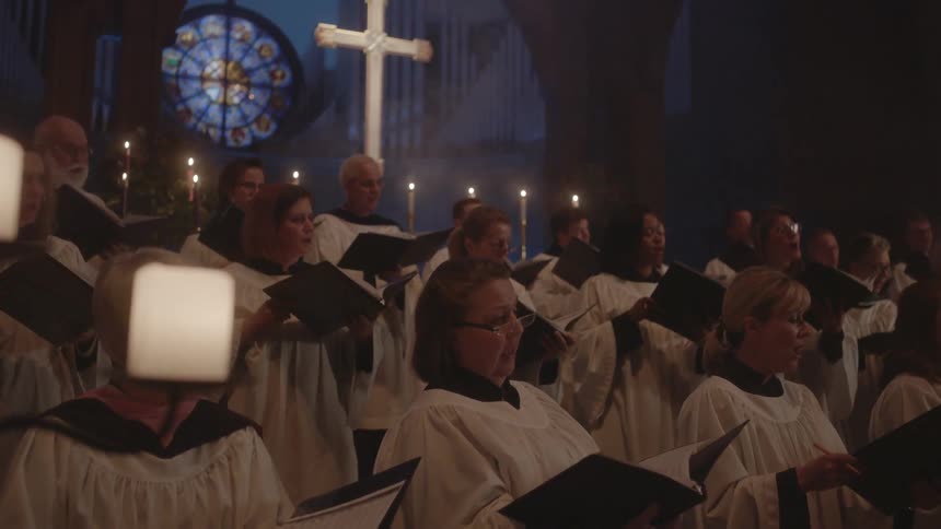 A group of people in a church holding books