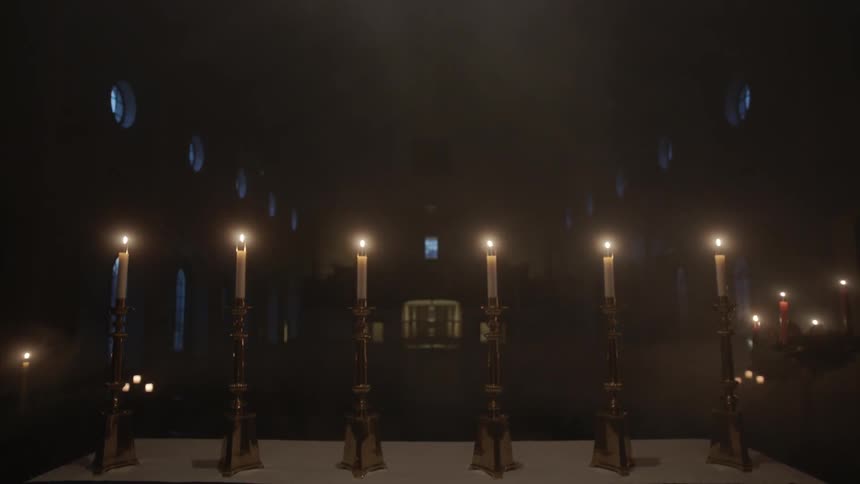 A row of candles sit on a table