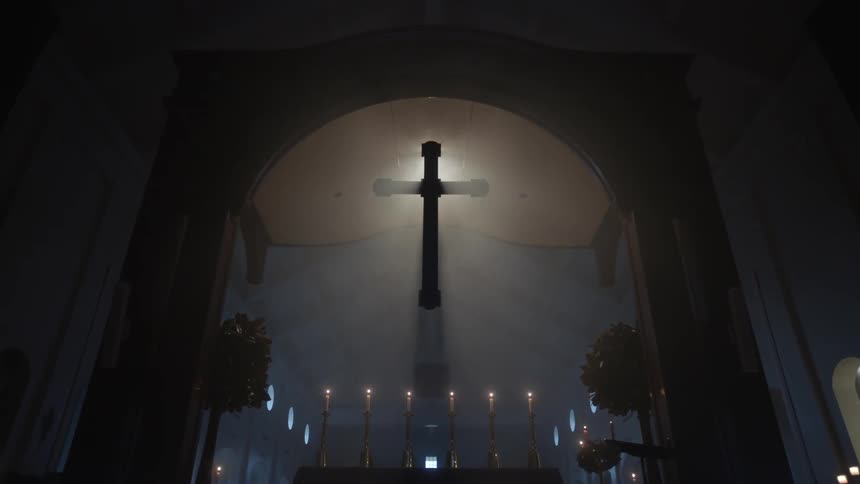 Sunlight shining behind a cross in a church