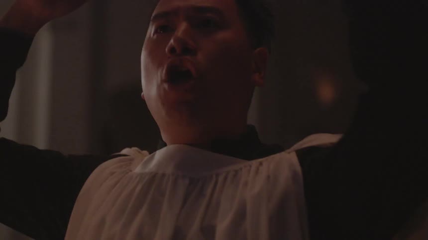 A church choir performer gestures during a service
