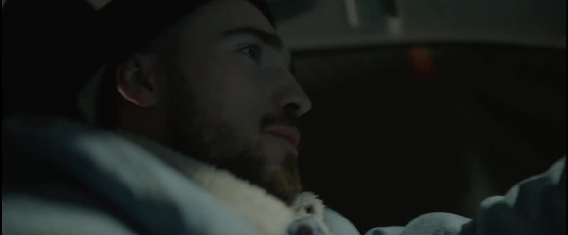 A man gasps and looks surprised as he drives