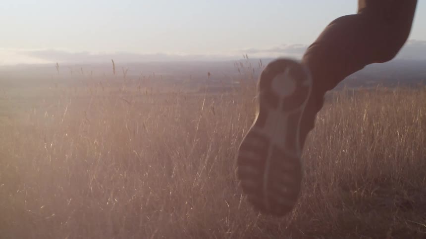A man runs across a grassy field