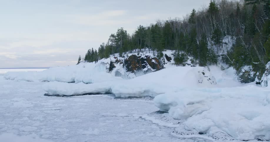 A frozen lake beside some trees