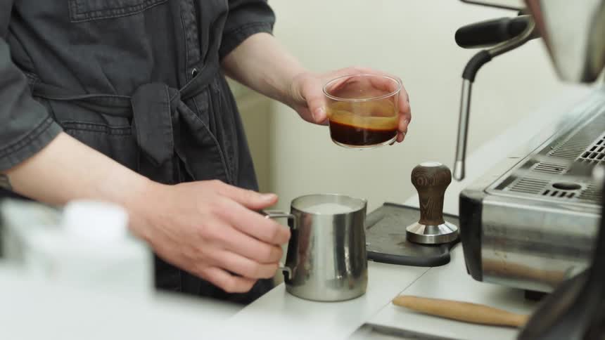Barista prepares espresso coffee in a restaurant