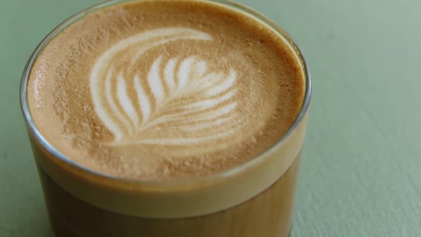 Coffee is in a cup with a design