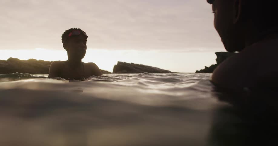 Two men swimming in water