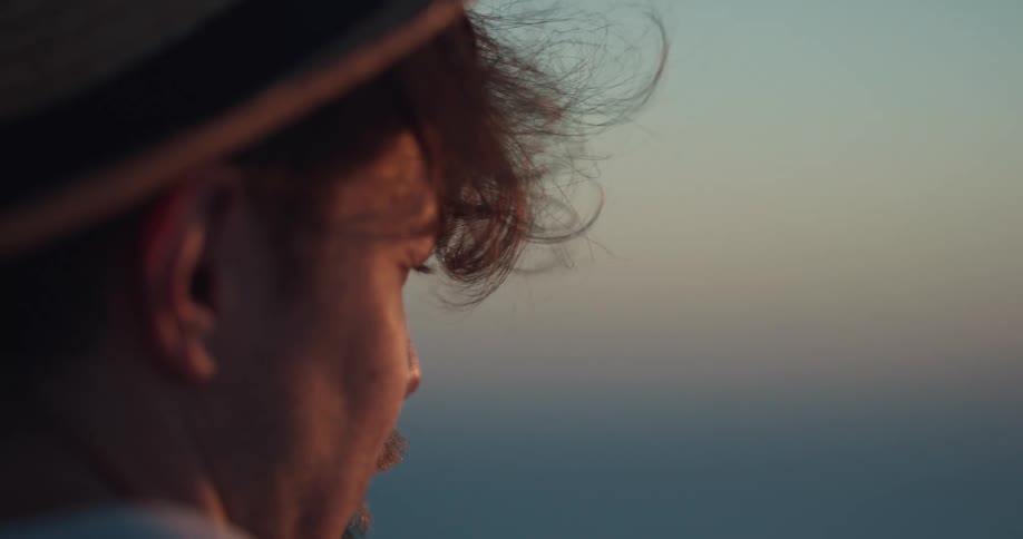 A man is watching the sunset outdoors