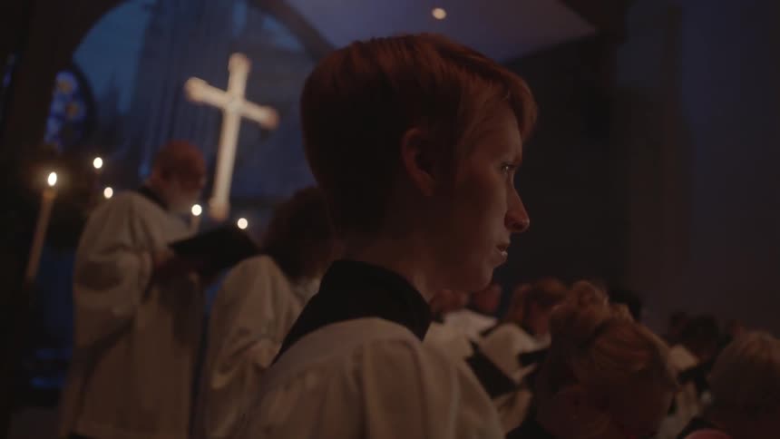 A church choir holds their books waiting