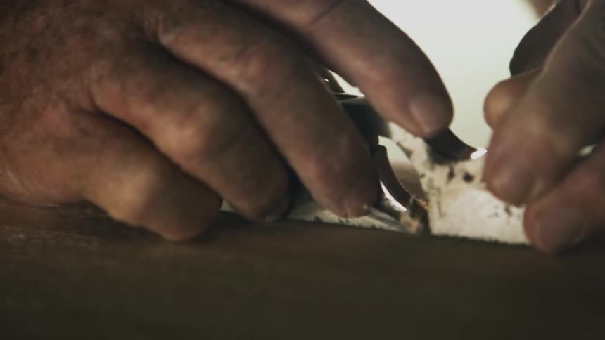 Person trimming wood
