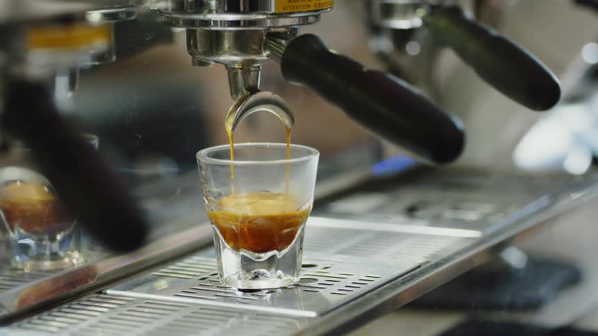 Coffee is brewing in a glass
