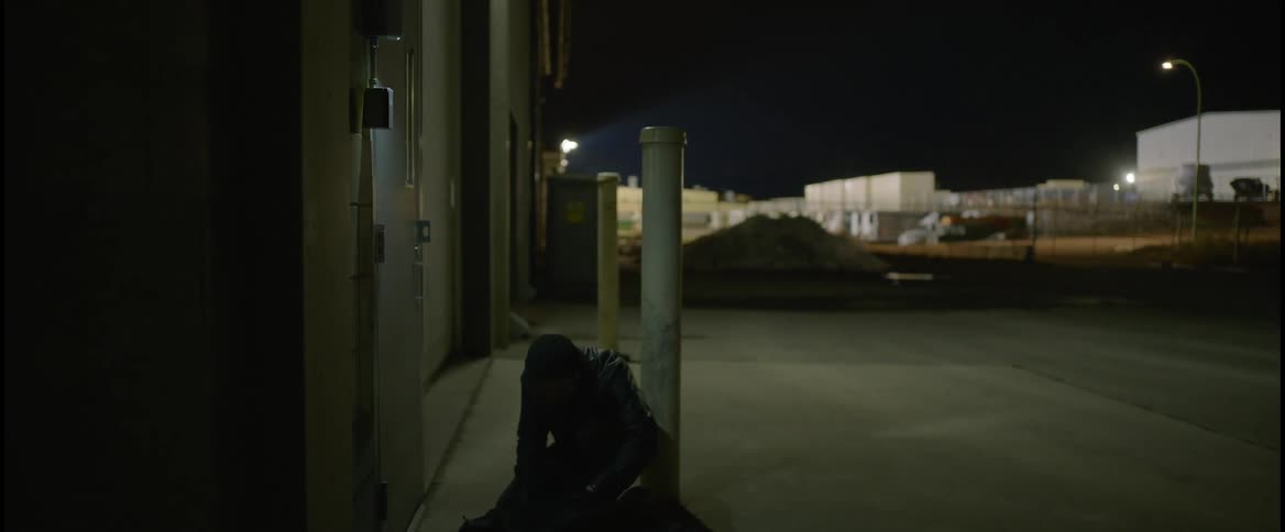 Thief carrying a bag breaks into a building at night