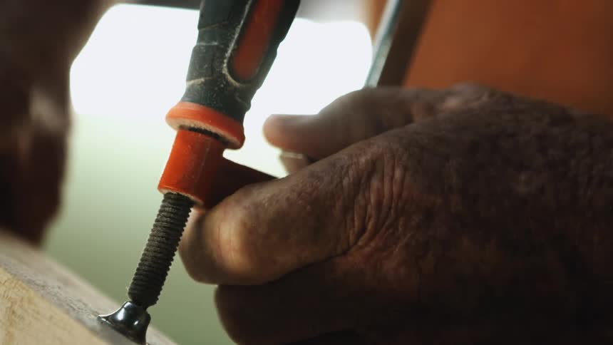 A person using a tool on a piece of wood
