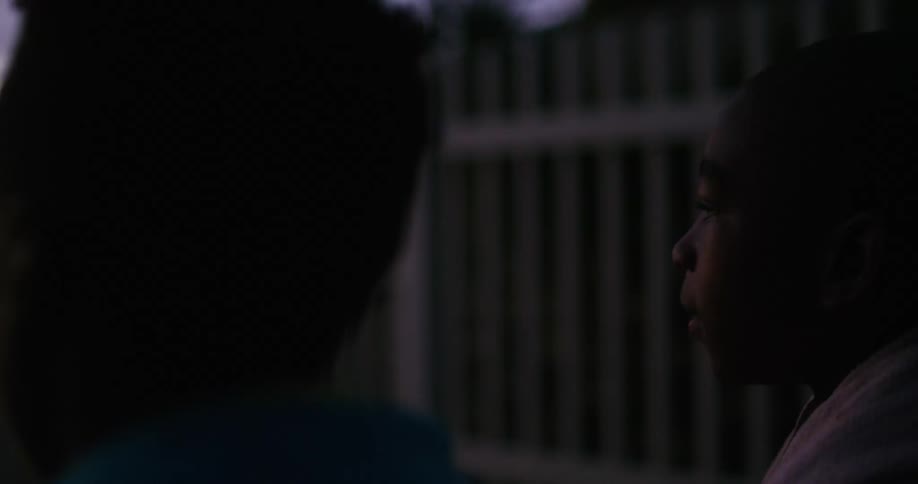 Young couple standing outdoors watching the sunset on the tropics