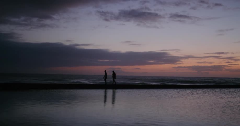 People walking beside water