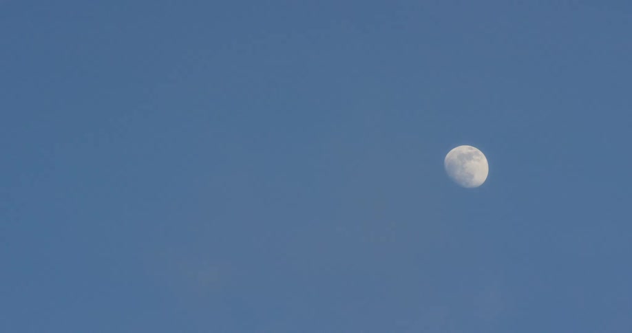 Clear view of the moon in a blue sky