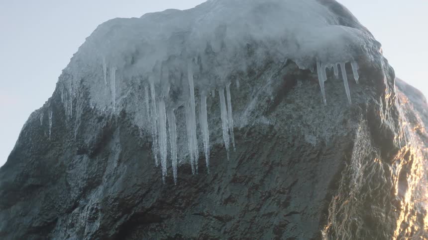 A rock is covered with ice