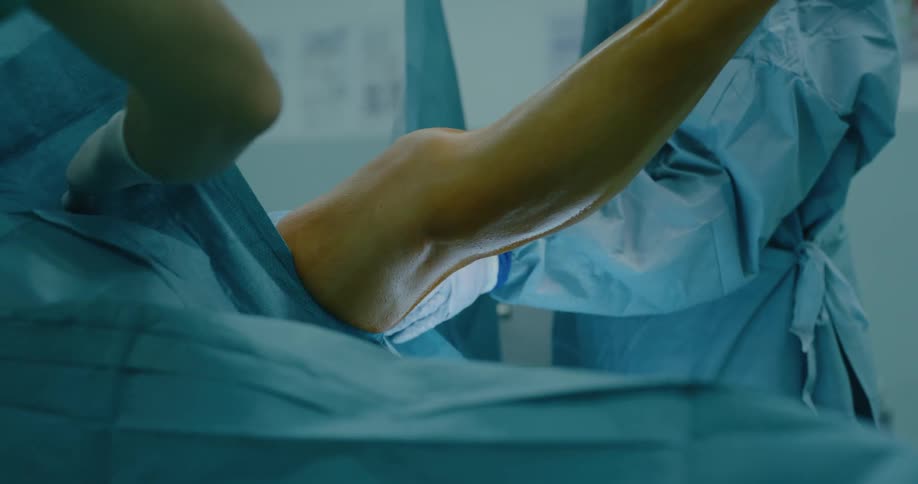 Surgeons covering a patient with surgical cloth inside the surgery room