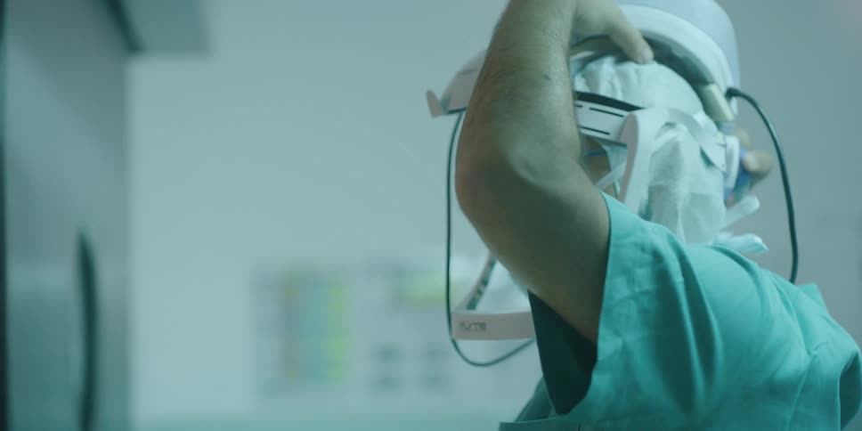 Surgeon wearing specialized headgear before entering surgery
