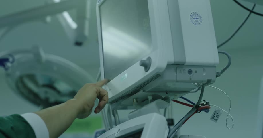 A nurse uses a touchscreen display monitor in the hospital