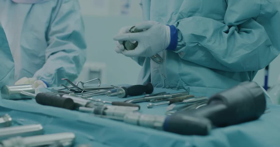 Two doctors in a surgery room with tools