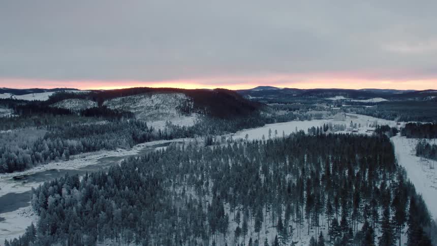 A snowy landscape at sunrise