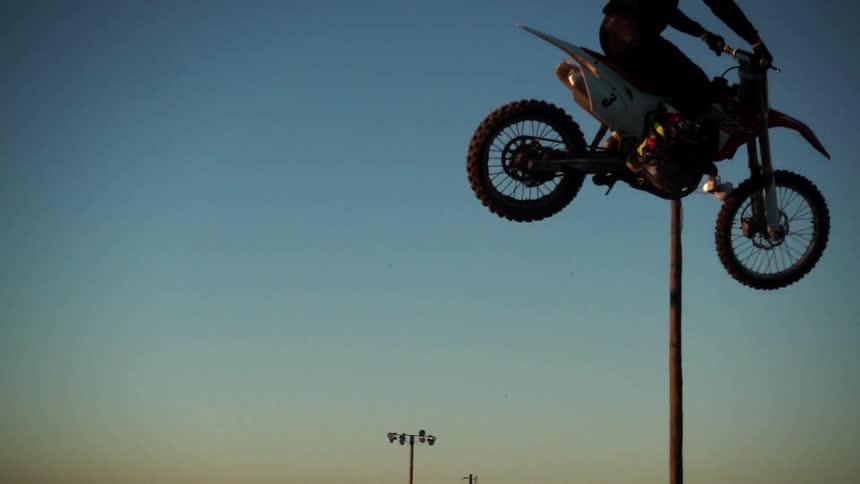 Motorcycle jumping a gap on a clear day