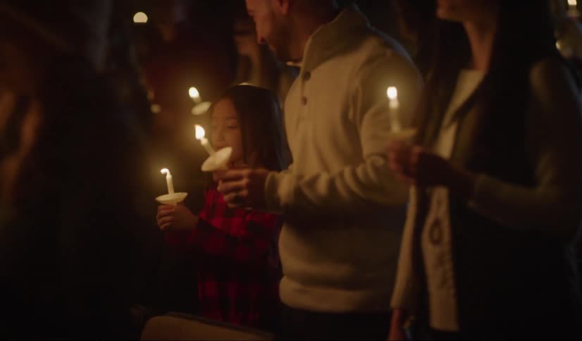 People in church holding candles