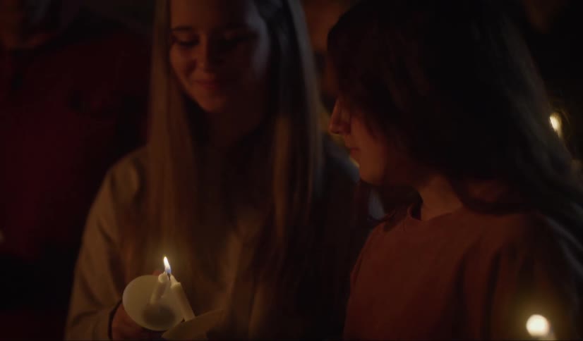 People in the church lighting candles