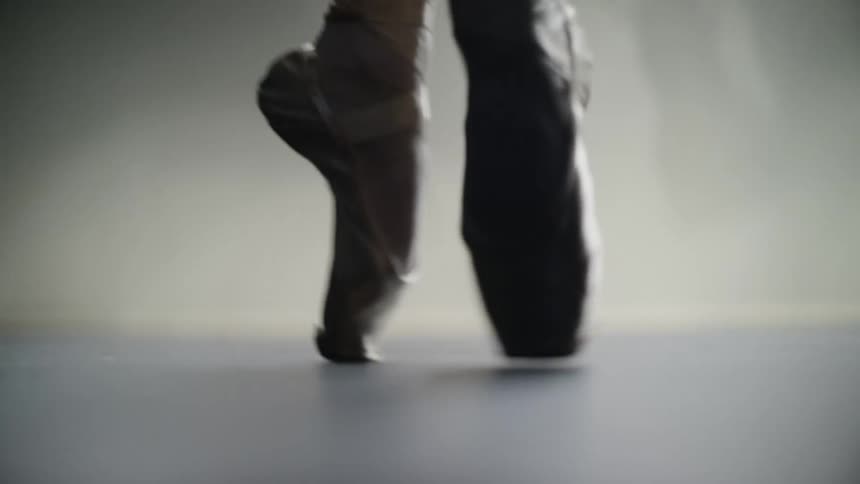 A ballet dancers feet dancing on pointe across the floor