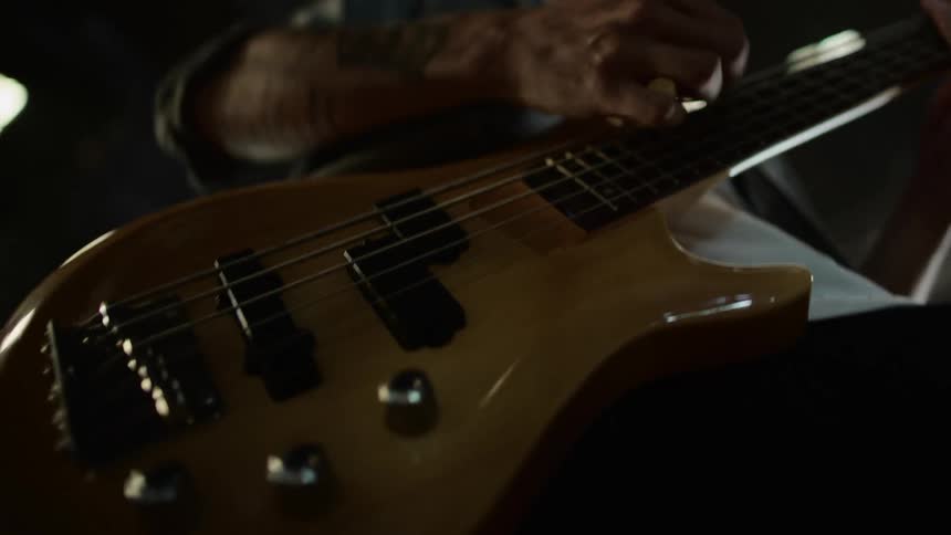 Guitaristplays electric guitar standing in large building