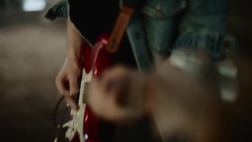 A man is playing an electric guitar on a stage