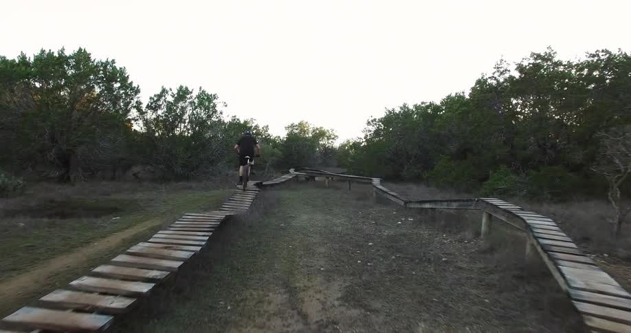 A man rides a bike over a course