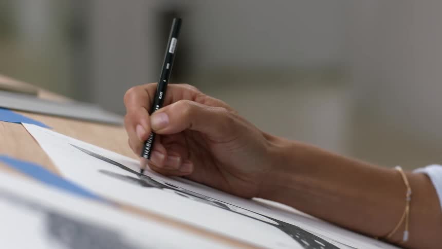 A view of someone sketching on a piece of paper