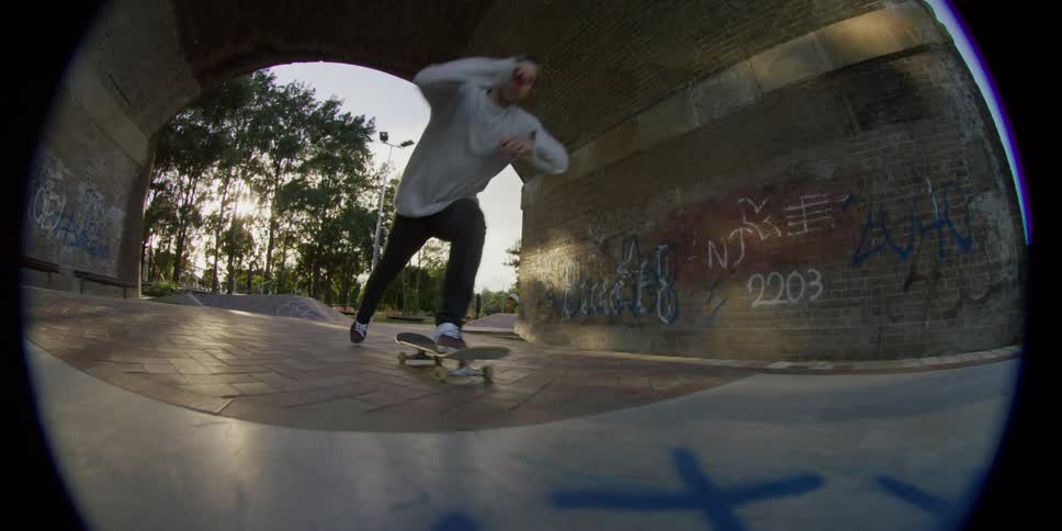 A man riding a skateboard in a skatepark