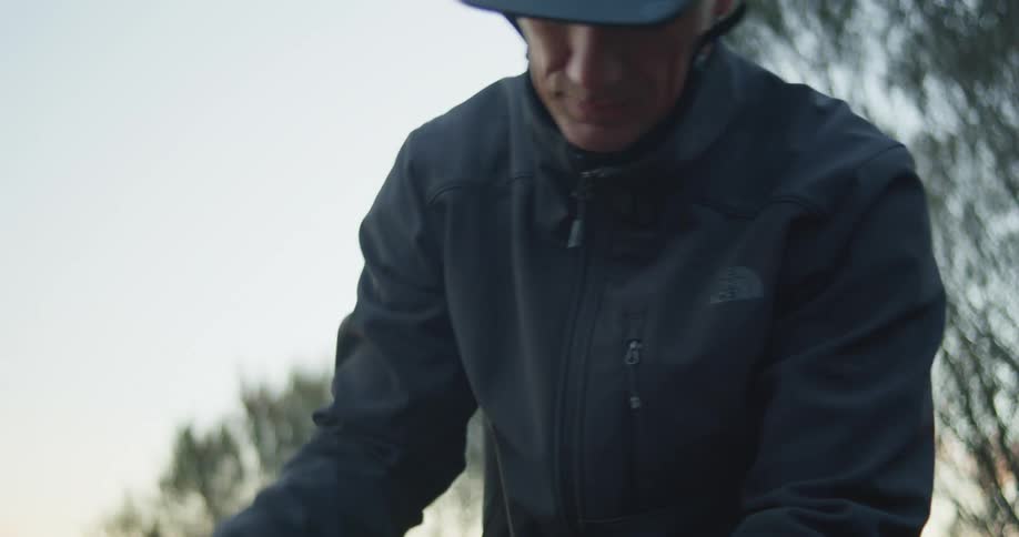 A man is fixing the chain on his bicycle