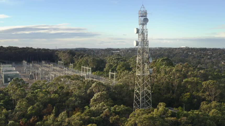 A utility power company with a tower high in the sky
