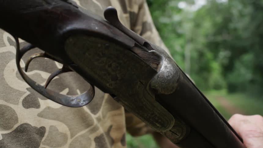 A man closes the end of a gun