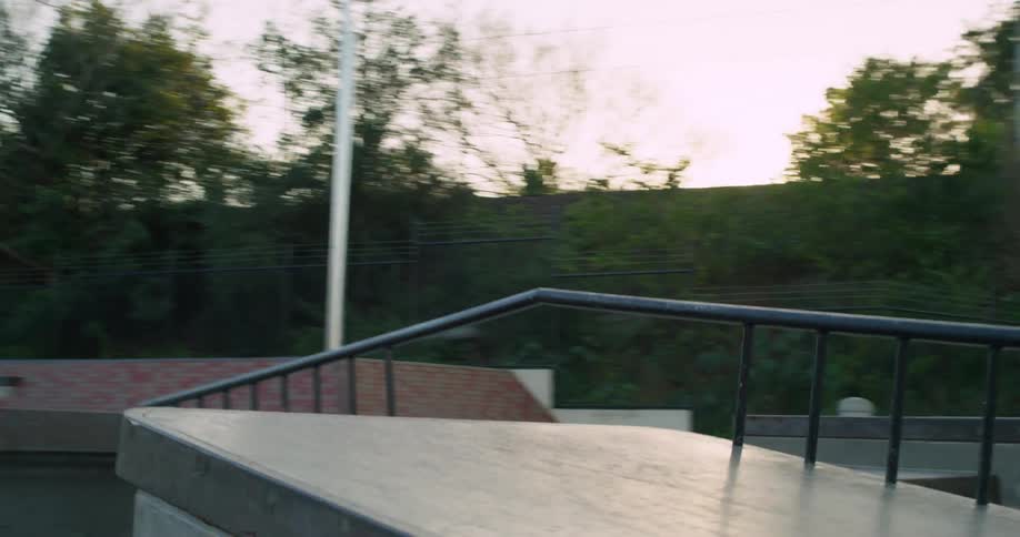 A man skateboards over a jump in a public park