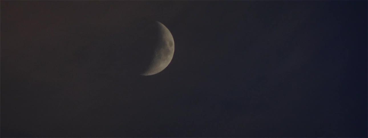 The moon is seen in the night sky