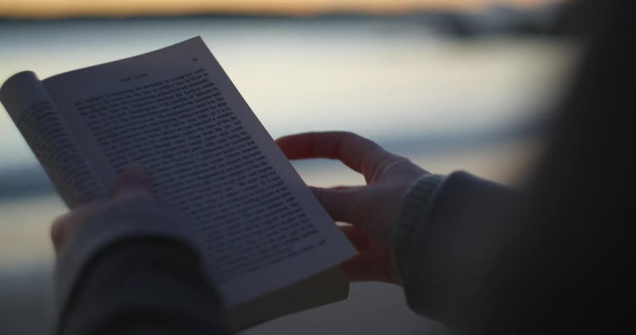 A person sitting outside reading a book